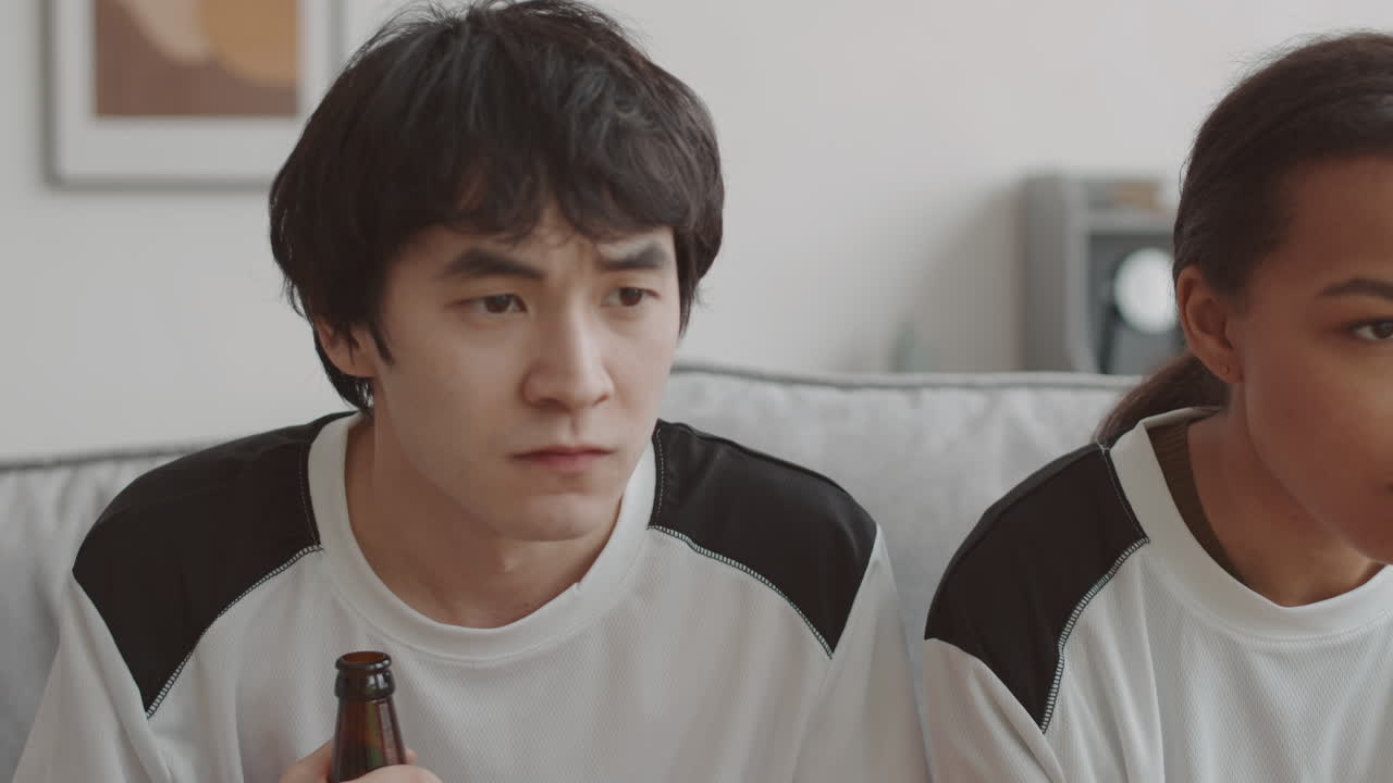 Nervous Asian Man Watching Movie