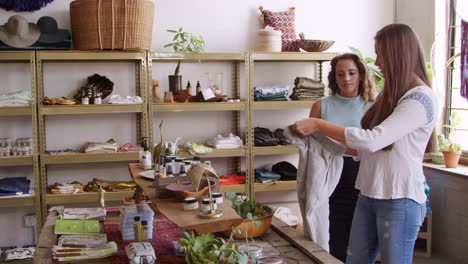 Female-shop-assistant-helping-a-customer-in-a-clothes-shop,-shot-on-R3D