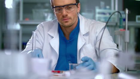 scientist in lab doing medical research. laboratory worker pour liquid