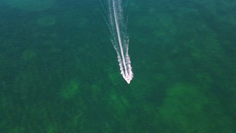 Stunning-aerial-4K-drone-footage-of-a-boat-gliding-across-the-enchanting-sea