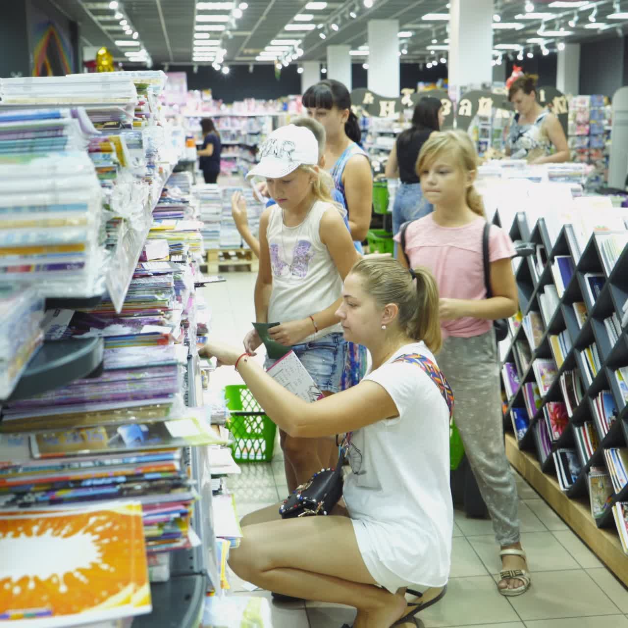 VINNITSA, UKRAINE - AUGUST 20, 2018: Shopping for school. Boy buying different products in stationery shop.