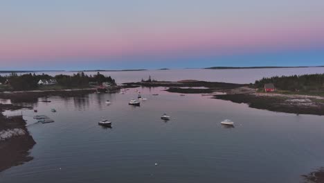 blue hour light beyond cape harbor, dynamic aerial shot tracking in