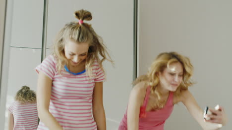 two young girlfriends teens learn to perform funny dance