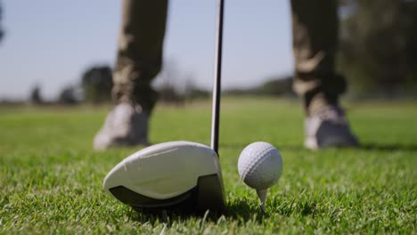 golf player preparing to tee off the ball with his club