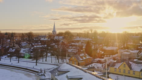 Beautiful-aerial-along-a-promenade-during-winter-months,-filmed-in-Haapsalu,-Estonia
