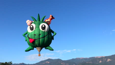 alien balloon floating across the mountains