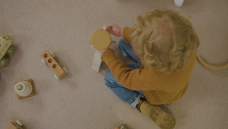 blond kid playing on the floor