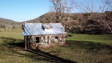 Low-aerial-pullout-old-stone-house-outside-of-Boone-North-Carolina,-Boone-North-Carolina-near-Blowing-Rock-North-Carolina,-Blowing-Rock-NC