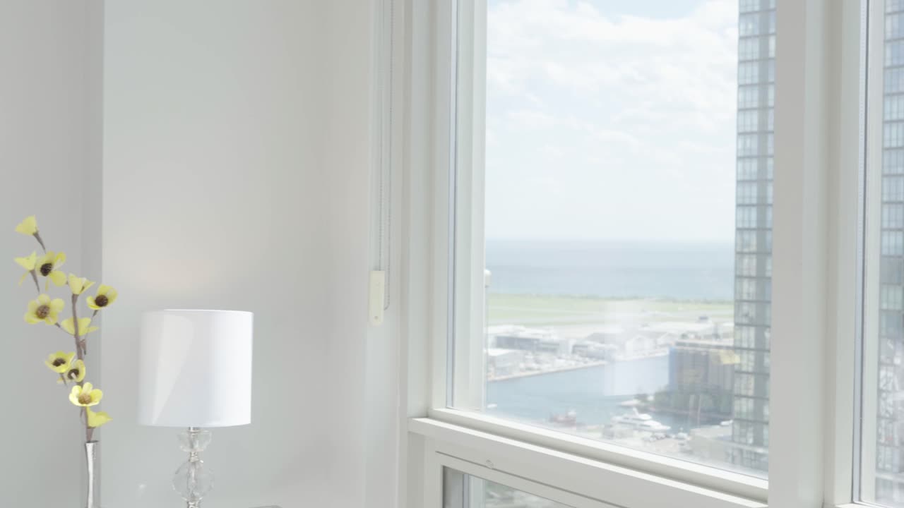 Reveal the view from the bedroom of a high-rise condominium unit