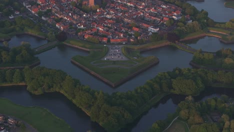 reveal shot of medieval city naarden netherlands vesting during sunset, aerial