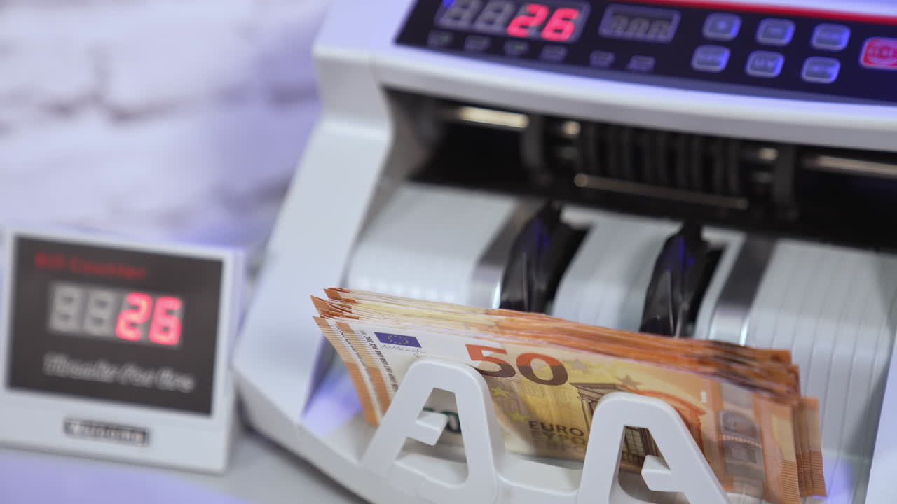 Electronic calculations of euros. Automatic equipment for counting paper money. Fifty euro banknotes in a modern counting machine.