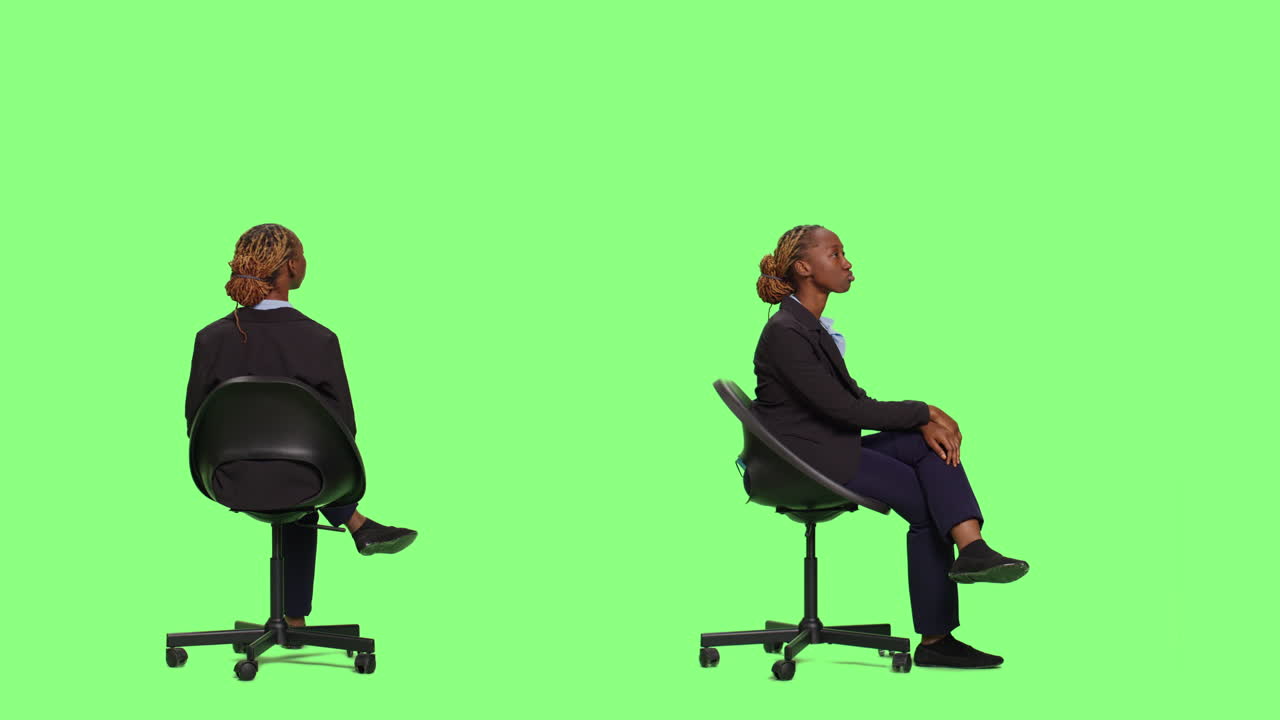 Businesswoman sitting on a chair in front of a green screen