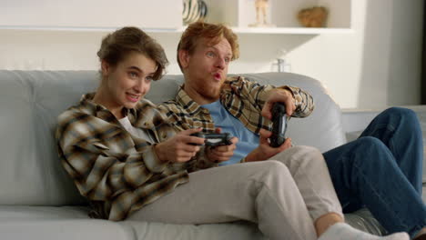 excited players enjoying video game. happy couple celebrating virtual victory.