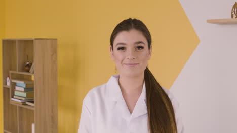 redhead doctor woman in white coat looking serious at camera