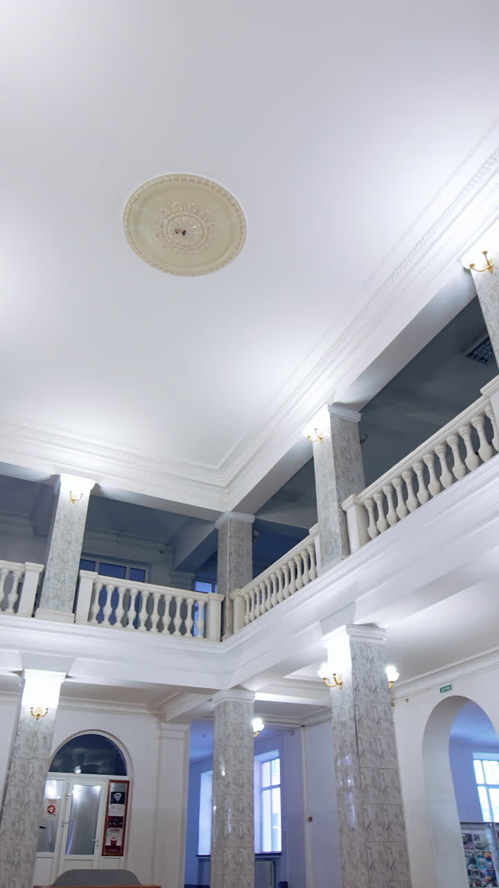 University entrance hall. Beautiful interior of a modern building. Modern new hall with bright lighting and tv. Vertical video