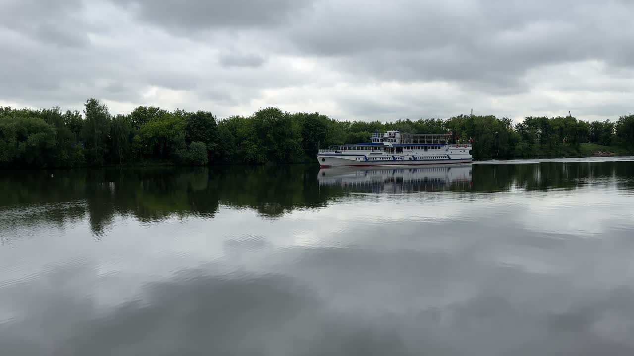 A beautiful reflection of a floating ship on a calm river (4K60)