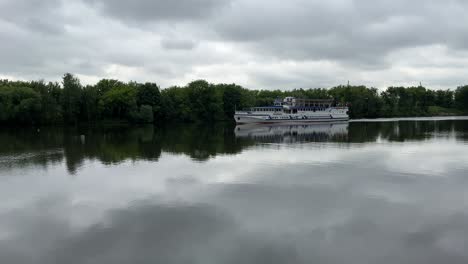 a beautiful reflection of a floating ship on a calm river (4k60)