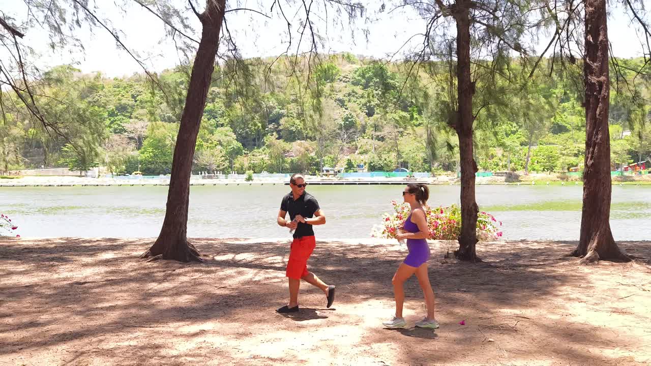 Couple enjoying a walk by the lake in a park