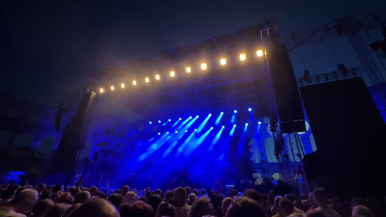 large concert in Pula colosseum with blue lights and fog, Croatia