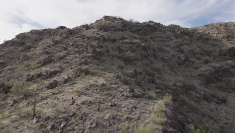 Aerial-shot-of-reveal-of-Phoenix-Arizona-suburbia-over-Mummy-mountain-during-daytime-in-Arizona,-USA