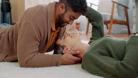 couple, kiss or bonding on floor in house