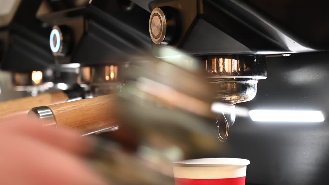 Close up of a barista making a coffee at a cafe with a professional machine