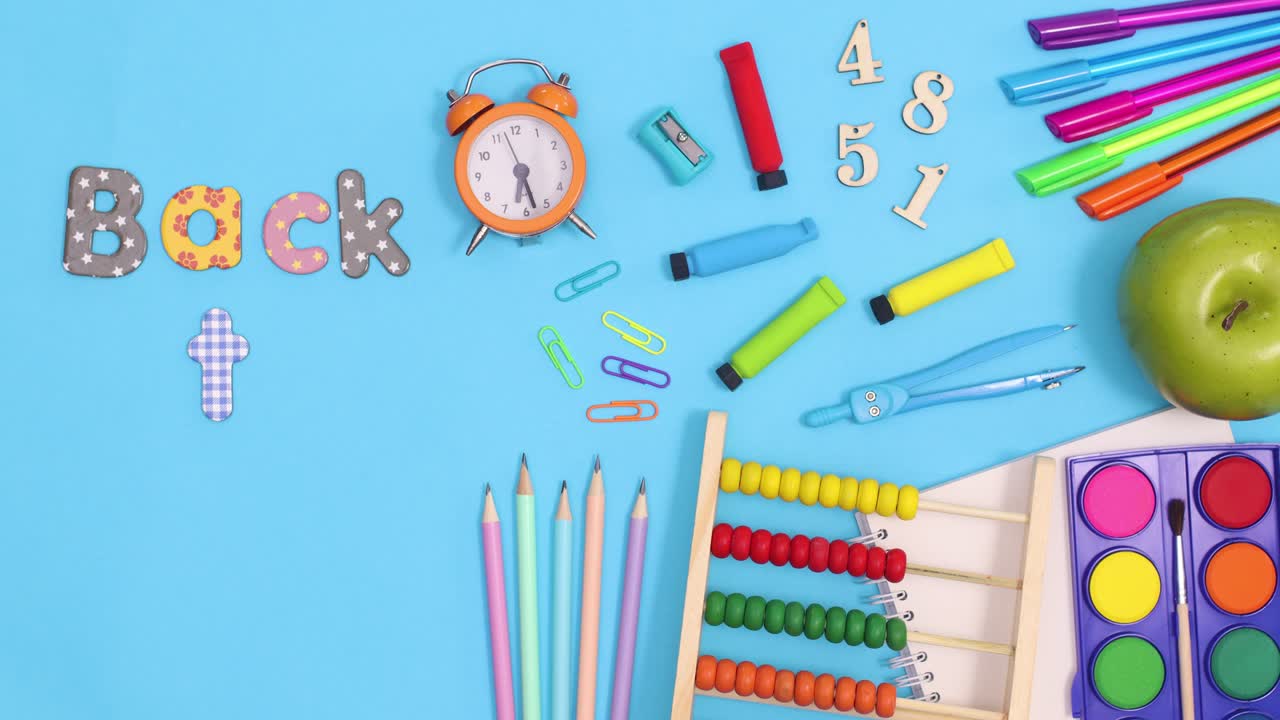 Back to school stationery and text appear on blue theme. Stop motion