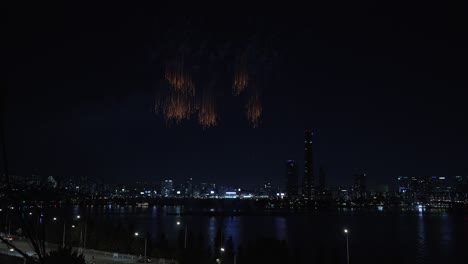 fireworks exploring in seoul sky at night display of the seoul international firework festival at the yeouido han river 2024, view of hanwna skyscraper in yeouido