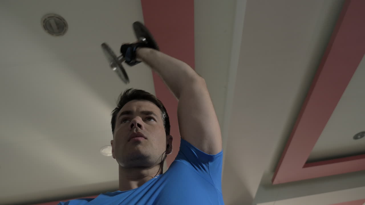 Sportive man working out with dumbbells