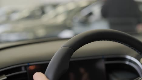 woman choosing a car in a car showroom