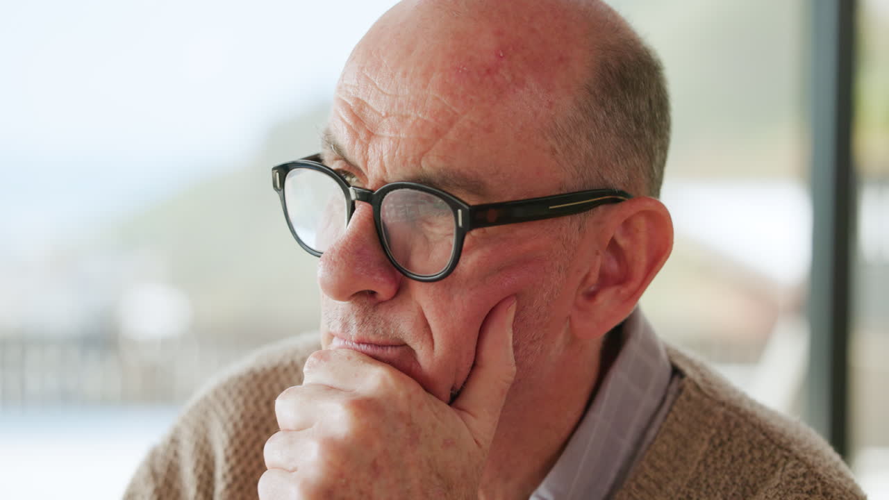 Close-up of Thoughtful Senior Man Wearing Glasses