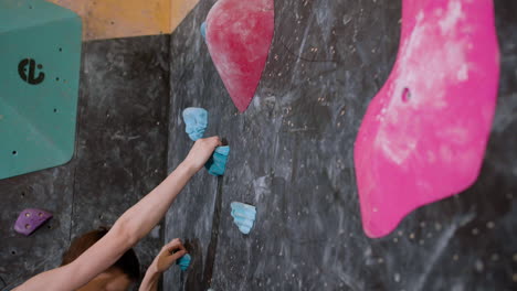 teenage boy bouldering indoors