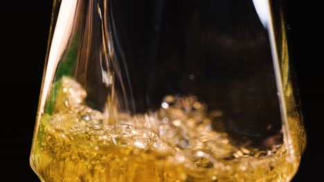 beer being poured, forming foam and settling