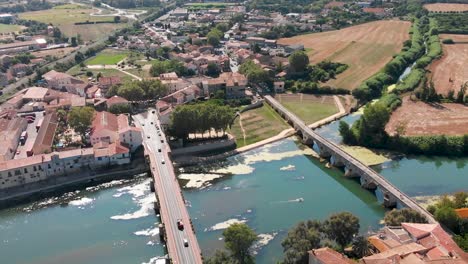 bird's eye view of a south french town with bridges over a river