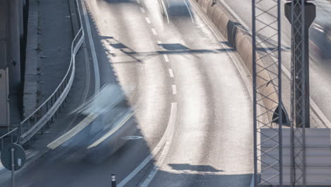 close up of vehicles flowing in timelapse on a busy city road, europe