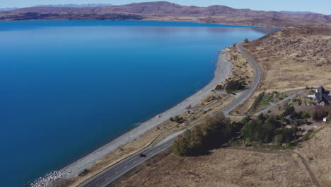 aerial drone shot of the highway around lake pukaki, south island new zealand