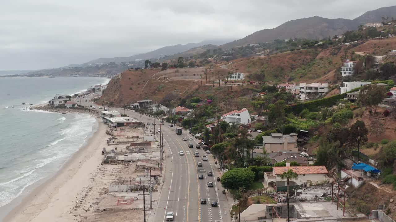 Wide aerial shot flying over Pacific Coast Highway near downtown Malibu after the Palisades Fire in Southern California. 4K