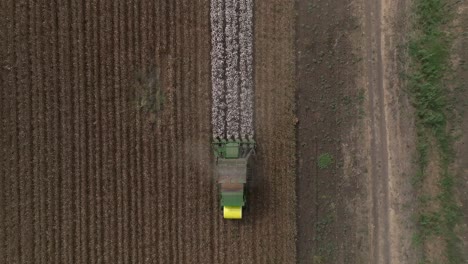 Cotton-picker-harvesting-a-field,-Top-down-aerial-view