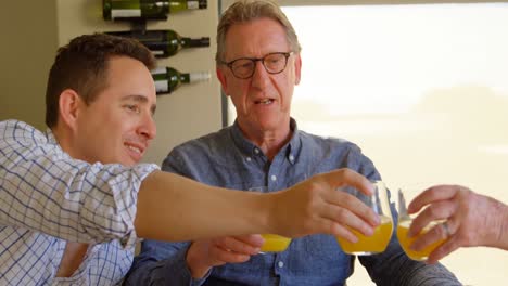 happy son and mother toasting glasses of juice at home 4k