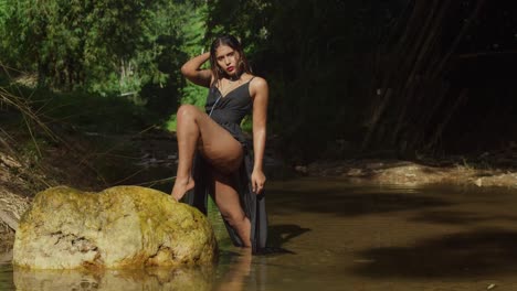 dressed in black, a young girl delights in the river's beauty.