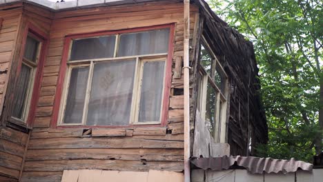 old wooden house with damaged siding