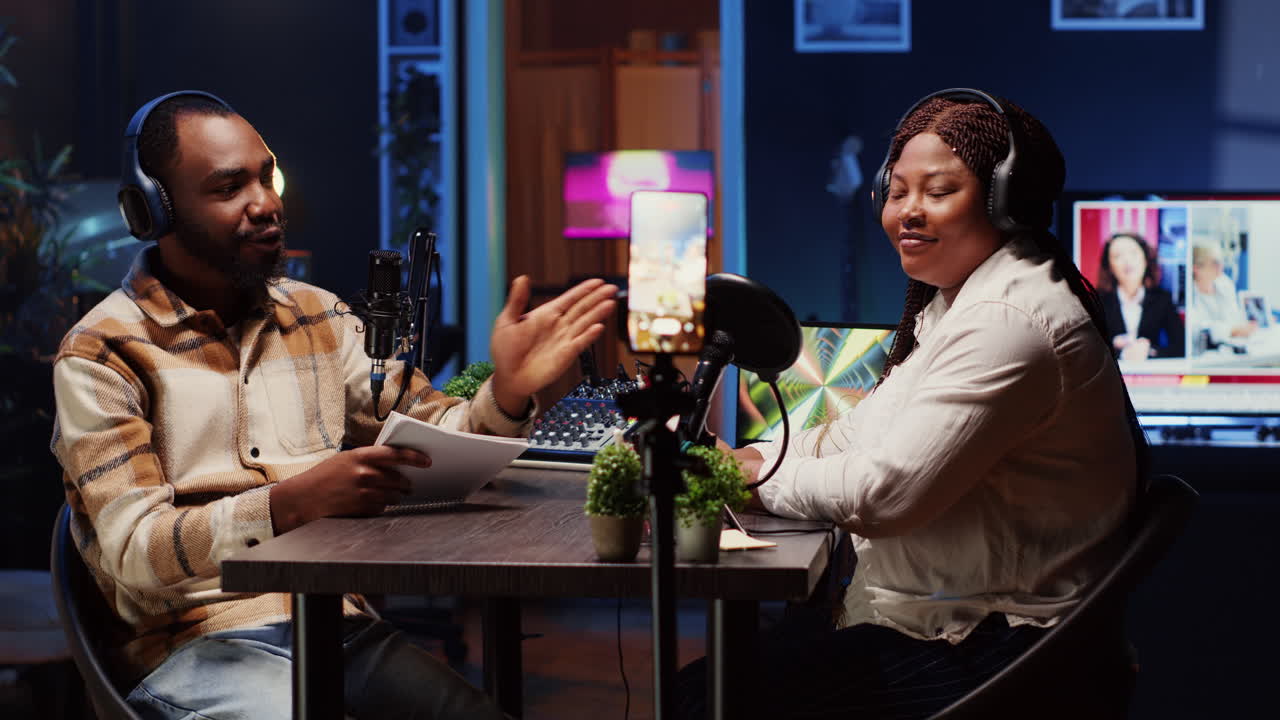 Podcast host using smartphone on tripod to record guest telling interesting story