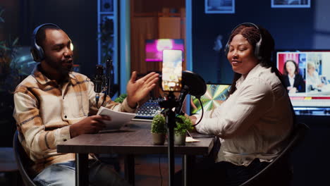 podcast host using smartphone on tripod to record guest telling interesting story