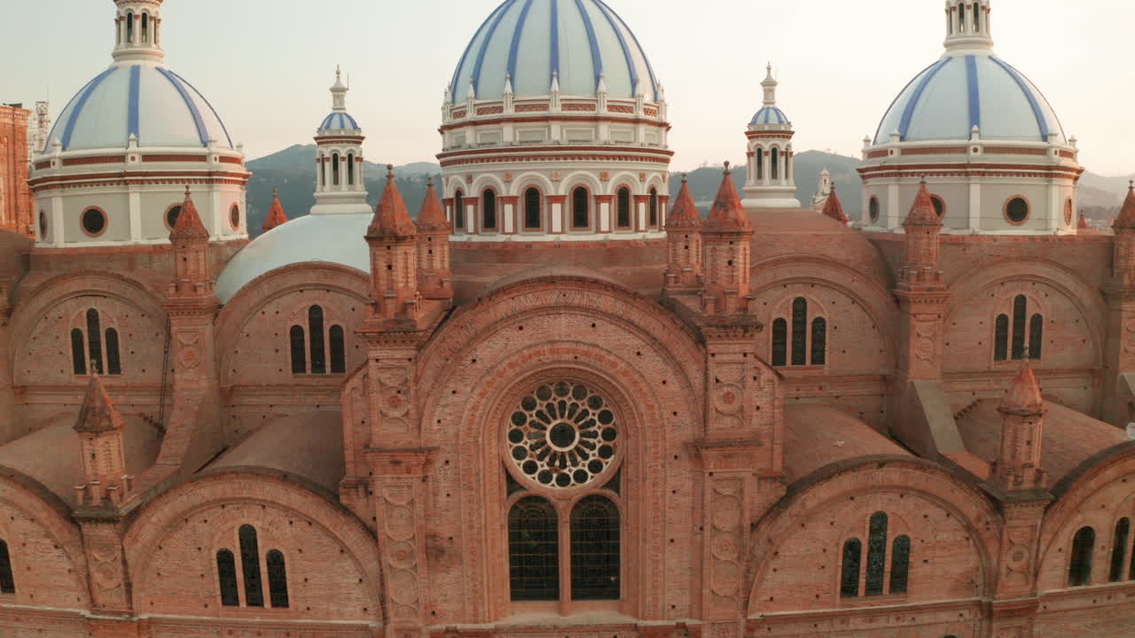 Stunning panoramic view of the historic center of Cuenca, Ecuador, with a focus on the majestic blue domes of the Cathedral of the Immaculate Conception.