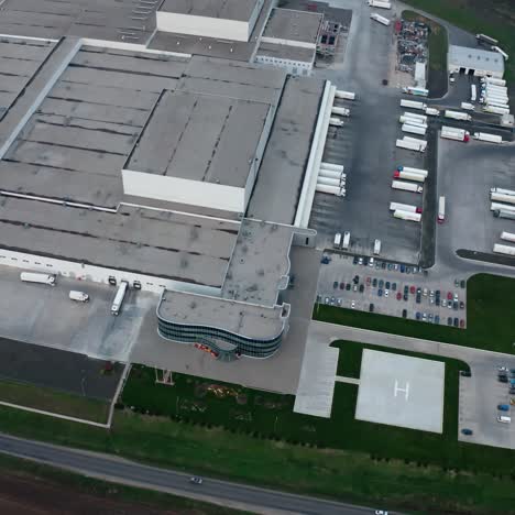 industrial exterior. modern factory on field. roofs of business complex with car parking. industrial zone on fields. aerial view.