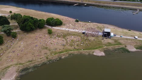music festival in two river conjunction with crowd of people, aerial drone view