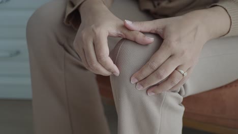 woman touching her painful knee