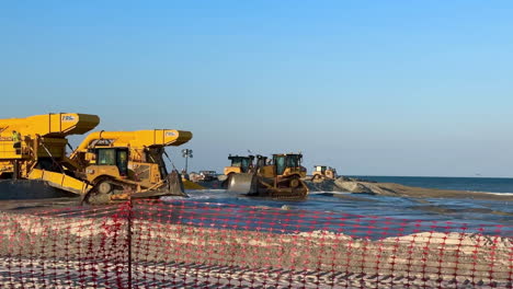 heavy construction equipment working on beach replenishment reclaim