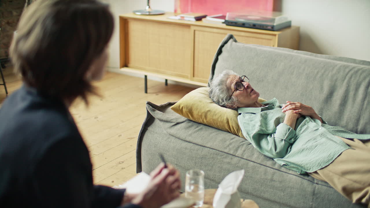 Elderly Woman Sharing Emotions with Psychologist on Therapy Session