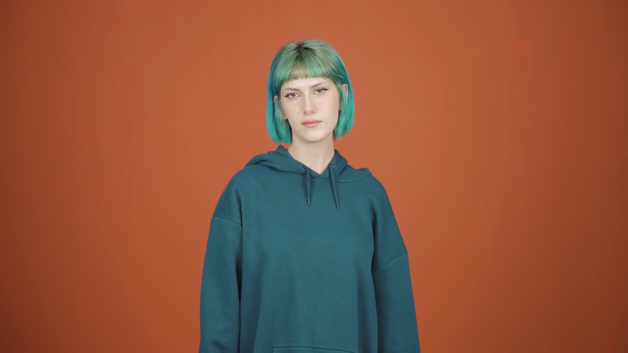 Young woman looking at camera with dull expression.